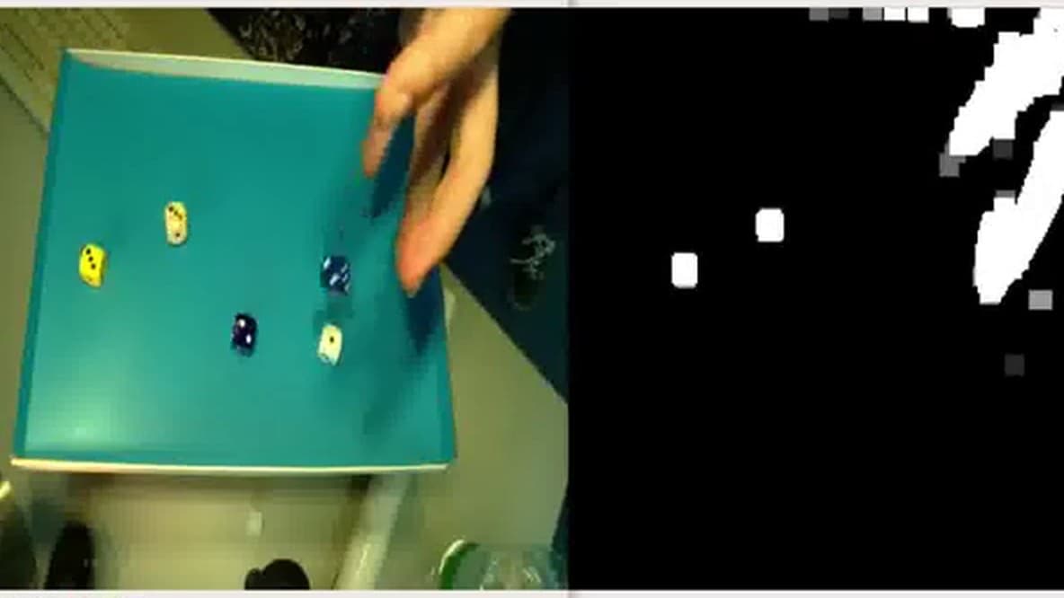 A frame of the live BEWiS run: the camera view of objects being placed on a table beside the foreground mask the network extracted from it